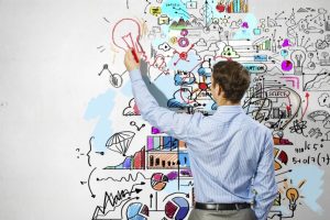 Businessman drawing sketches on wall